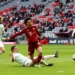 MUNICH, GERMANY - FEBRUARY 20: Leroy Sane of FC Bayern Muenchen is challenged by Nick Viergever of SpVgg Greuther Fuerth during the Bundesliga match between FC Bayern München and SpVgg Greuther Fürth at Allianz Arena on February 20, 2022 in Munich, Germany. (Photo by Alexander Hassenstein/Getty Images)